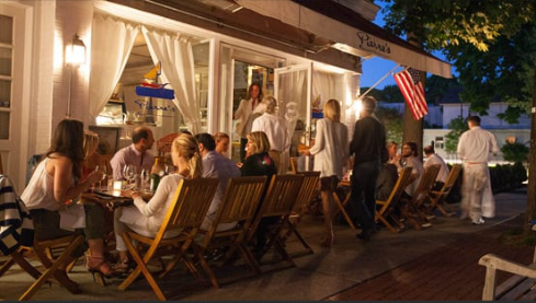 Luxurious outdoor dining at Pierre's Bridgehampton with oysters and champagne under Hamptons sunset.