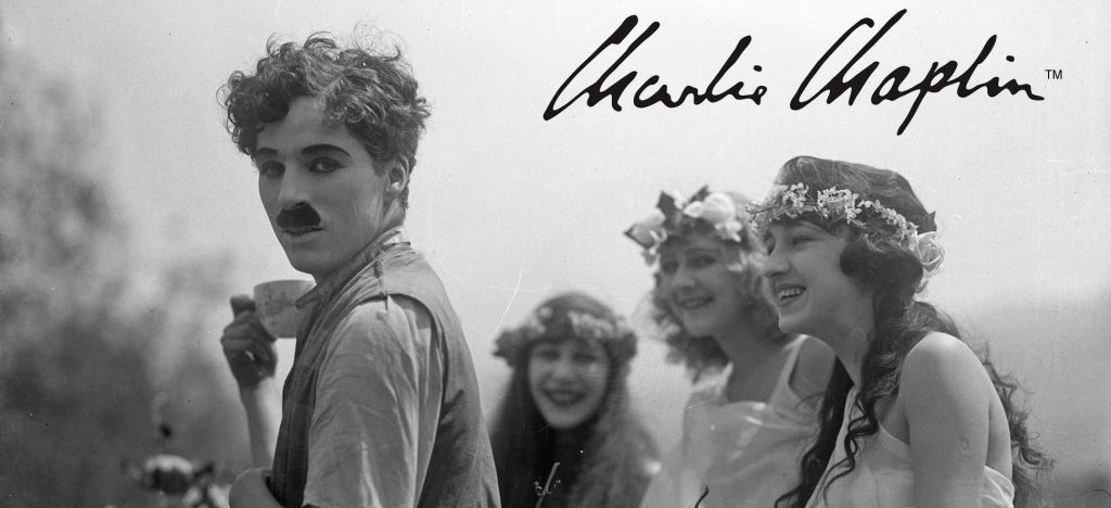 Charlie Chaplin with 3 flower girls