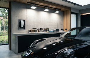 Alt: Modern garage with car, cleaning supplies, and charger