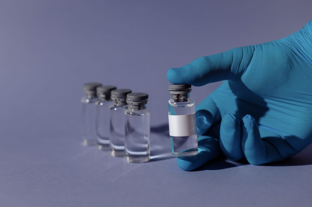 hand holding a glass vial courtesy of Thirdman on Pexels