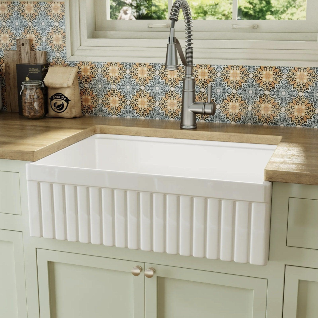 A fluted apron front reads as texture from across the room and as a handhold when you are leaning in.