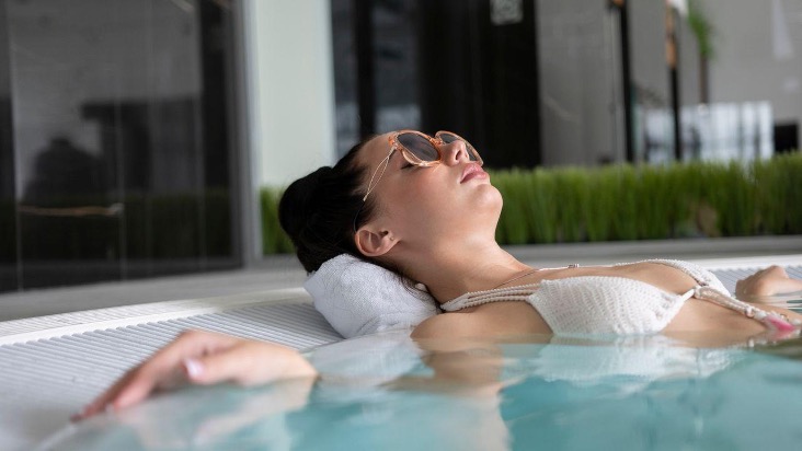 a woman in a bikini unwinding in a luxurious jacuzzi